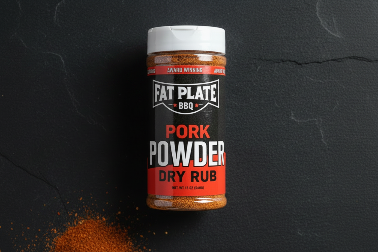 Jar of Fat Plate BBQ Pork Powder Dry Rub on a dark surface