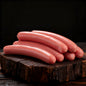 Raw hot dogs on a wooden cutting board with text about barbecue quality.