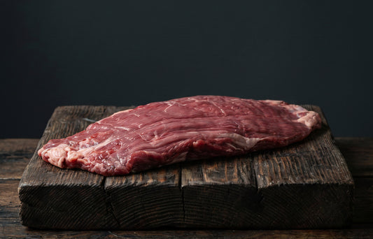 Promotional image of prime cuts of meat with cooking process and dining setup on a dark background.