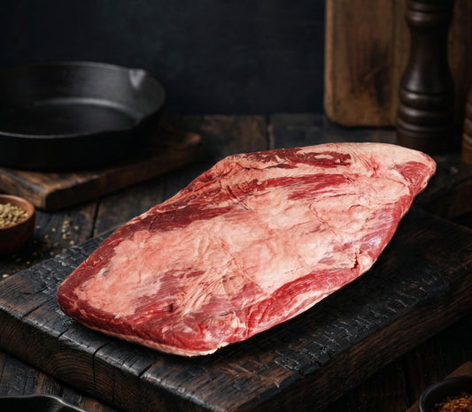 Raw brisket on a wooden cutting board with promotional text about quality, marbling, and flavor.
