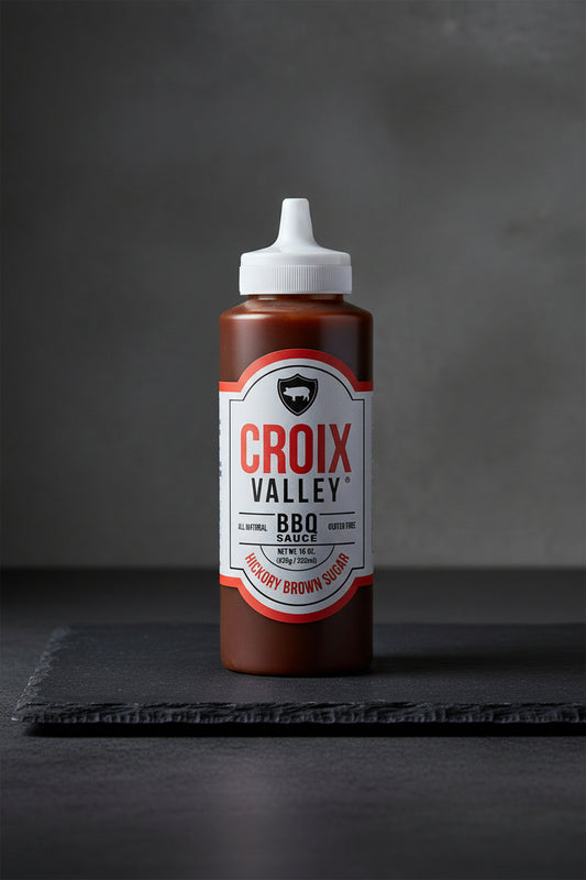Bottle of Croix Valley BBQ Sauce with a white cap on a black background