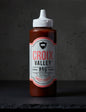 Bottle of Croix Valley Sweet Peach BBQ Sauce on a black background