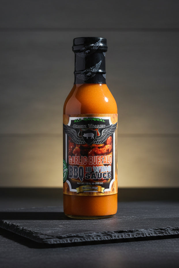 Bottle of Garlic Buffalo BBQ Sauce with a black label on a white background