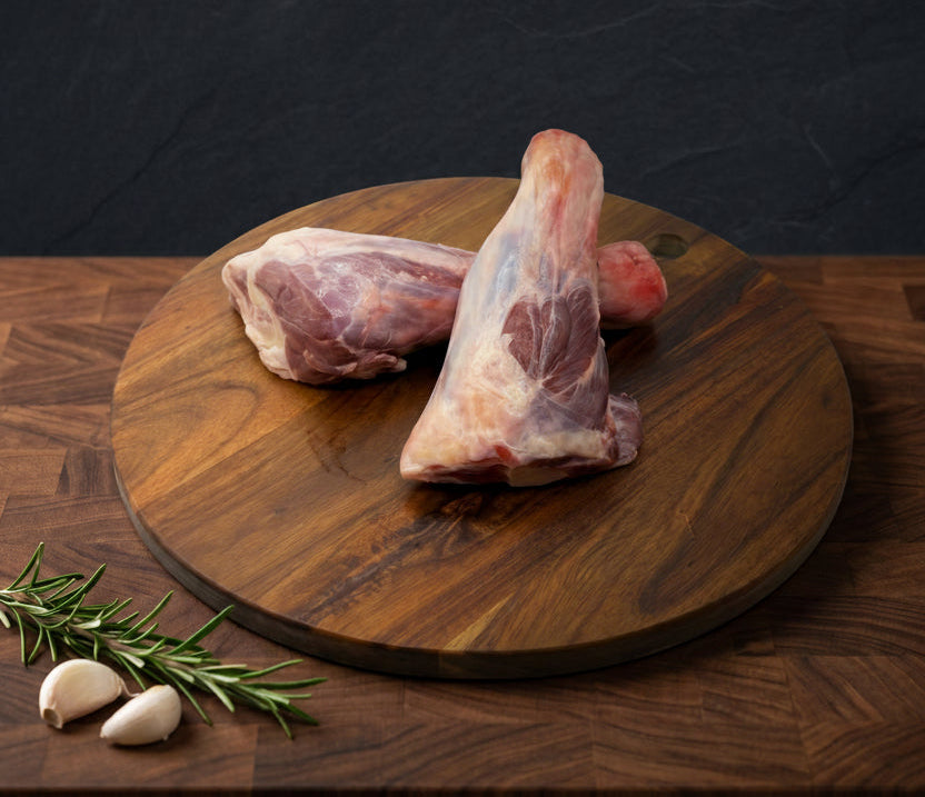 Raw lamb on a wooden cutting board with text about premium lamb.